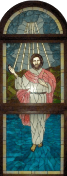 Stained glass Jesus behind church altar